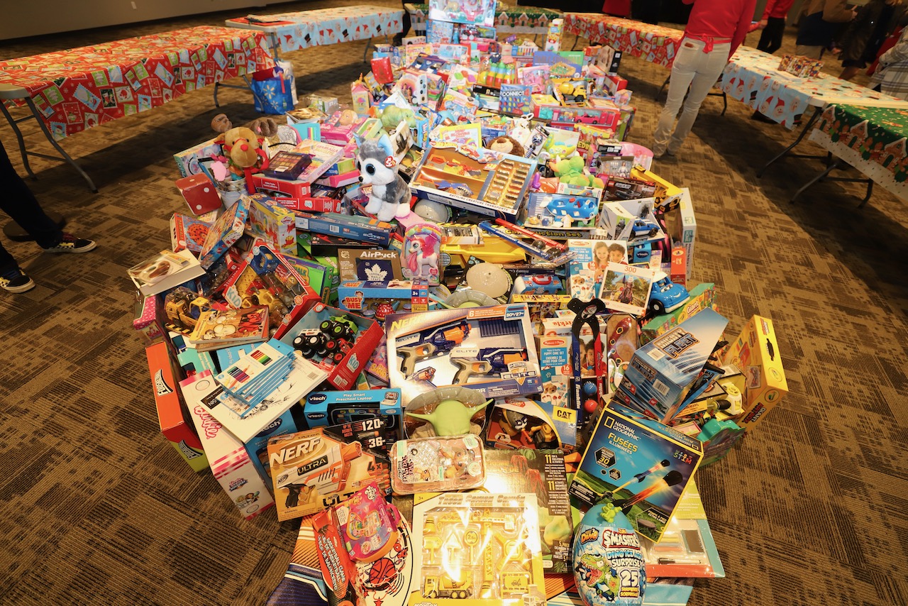 A dramatic mountain of donated Christmas toys and games ready to be distributed