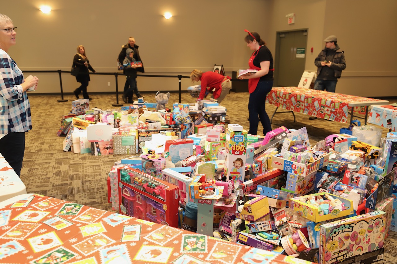 Volunteers arranging tables of donated toys before the breakfast opens